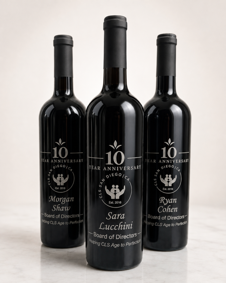 Three black wine bottles sandblasted with silver-filled 10-year anniversary artwork and personalized names