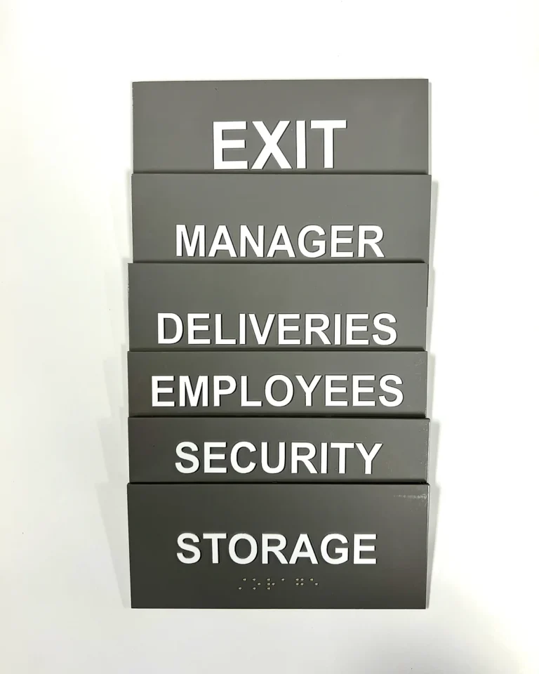 ADA-compliant room signs with laser-cut tactile elements and UV-printed clear Braille