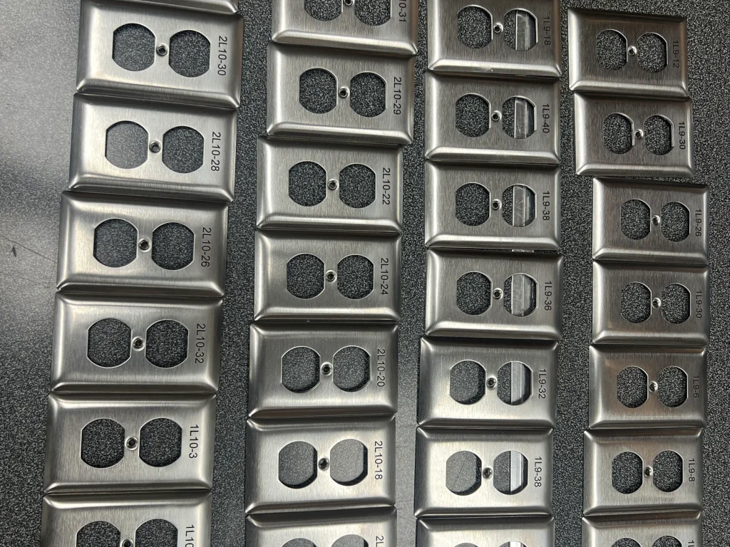 Batch of black stainless-steel switch plates marked with fiber laser engraving