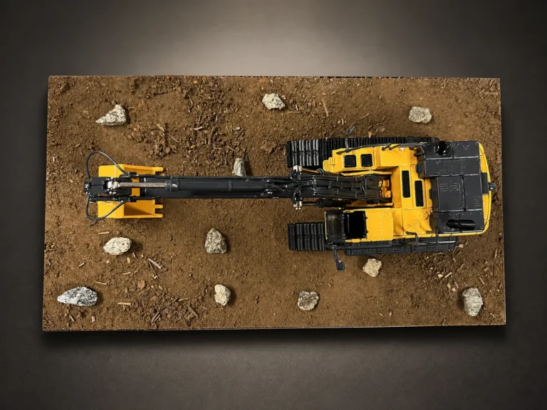 Custom excavator diorama with a detailed dirt and rock display base