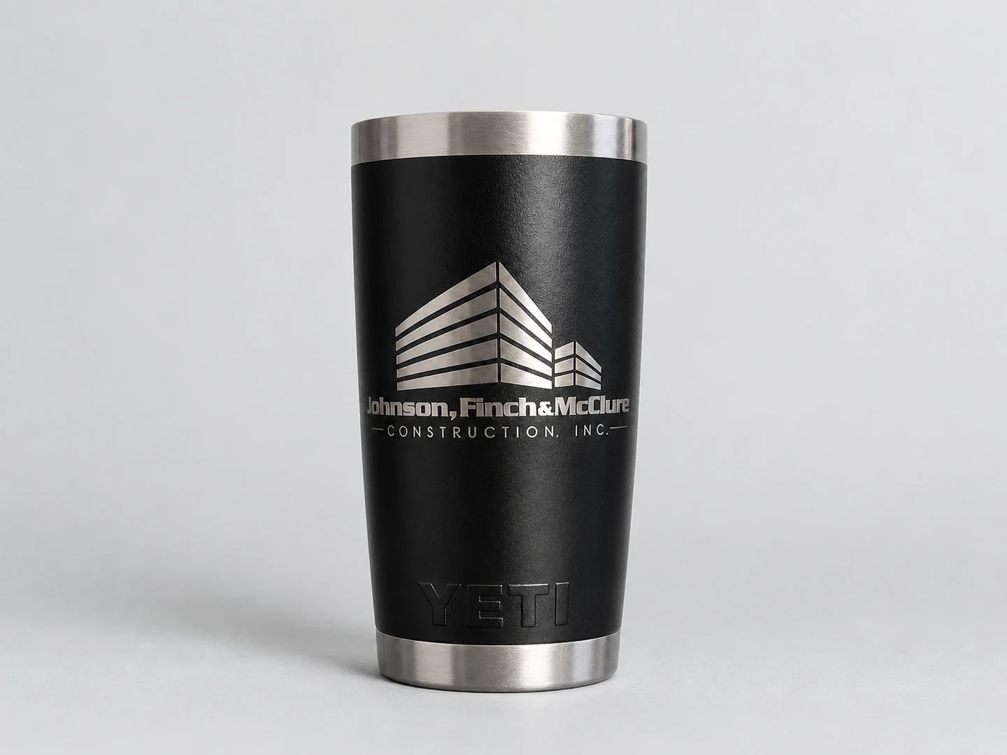 Black YETI tumbler laser engraved with the Johnson, Finch and McClure Construction logo
